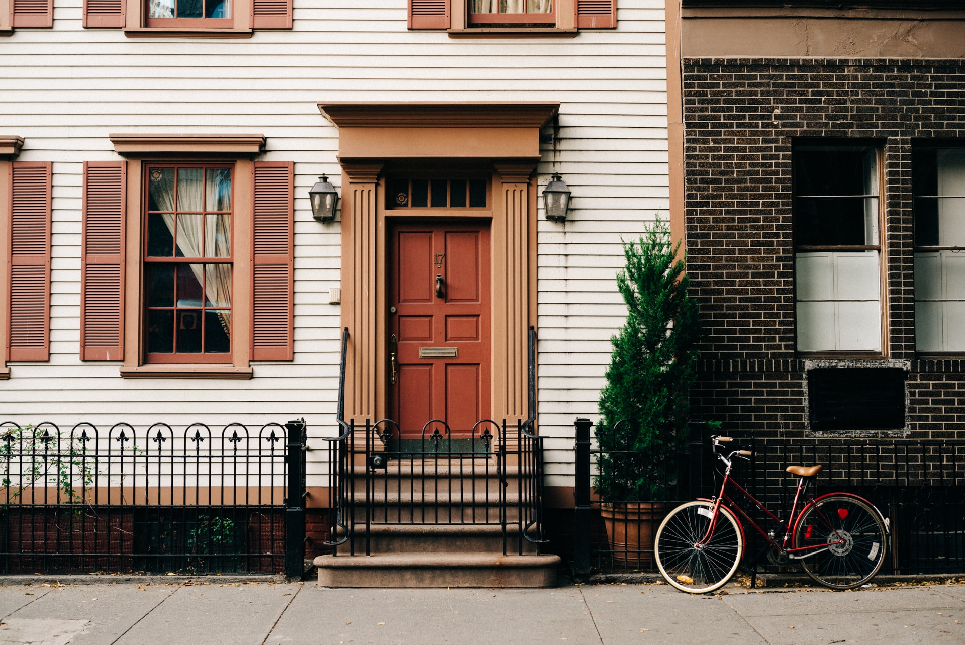 House with a red door and a bike in front