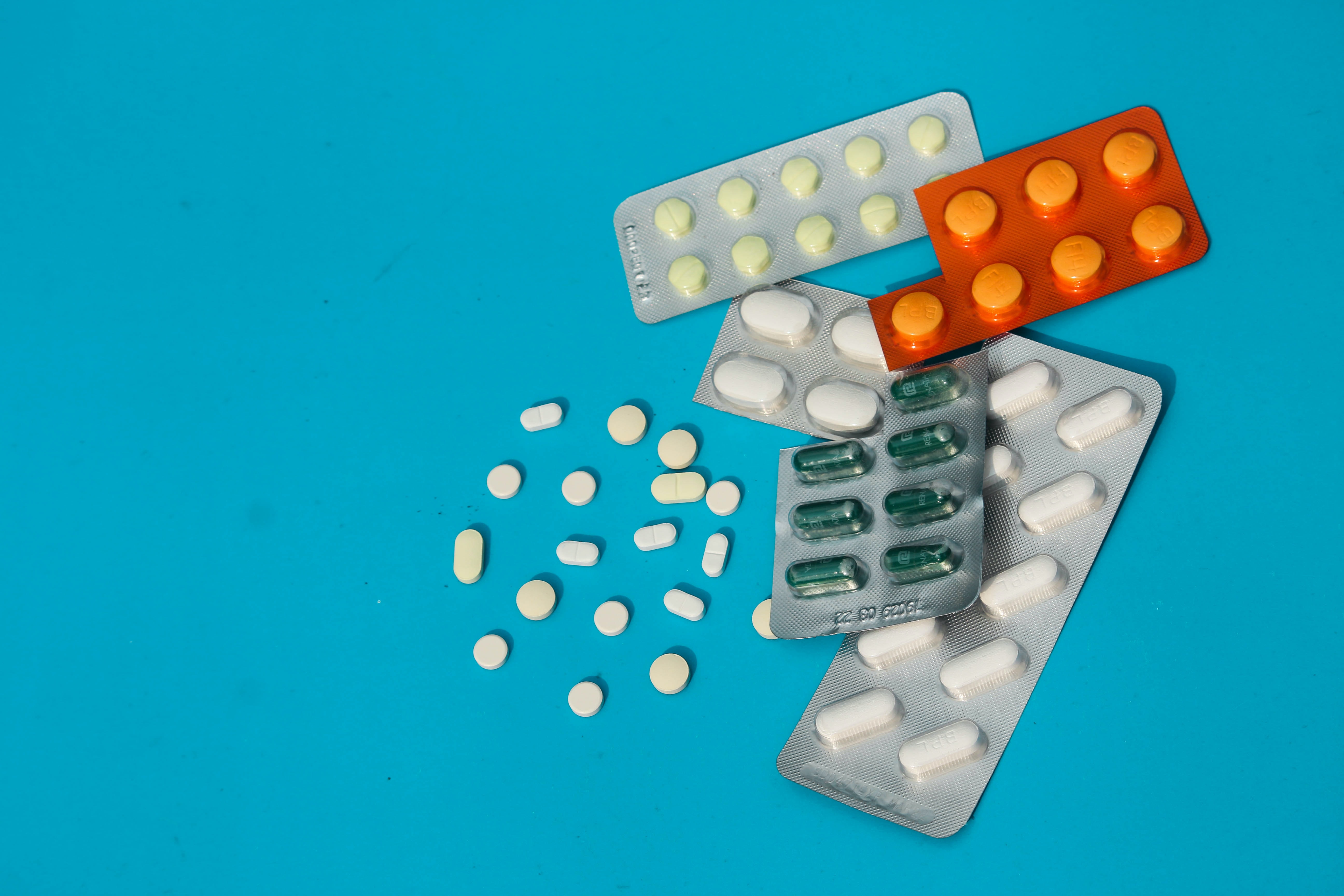 Various medicine pills on a blue background