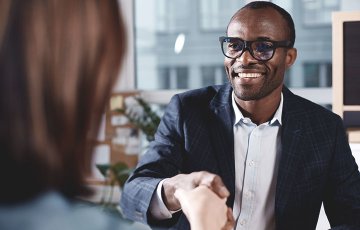 man shaking hands with a business development specialist