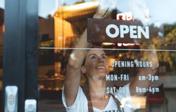 businesswoman hanging a sign