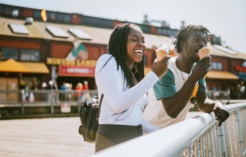 couple having fun eating ice cream cones