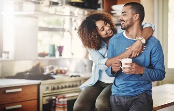 couple relaxing with coffee in the kitchen